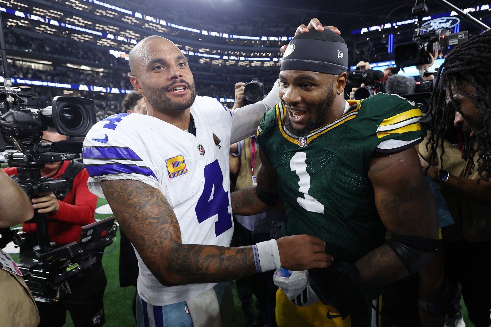Jogadores do Dallas Cowboys e do Green Bay Packers se cumprimentam após uma partida da NFL.