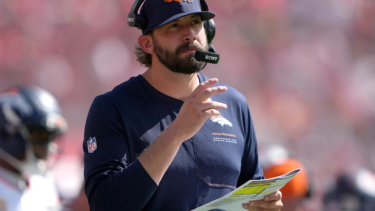 Integrante dos Denver Broncos observa o campo.