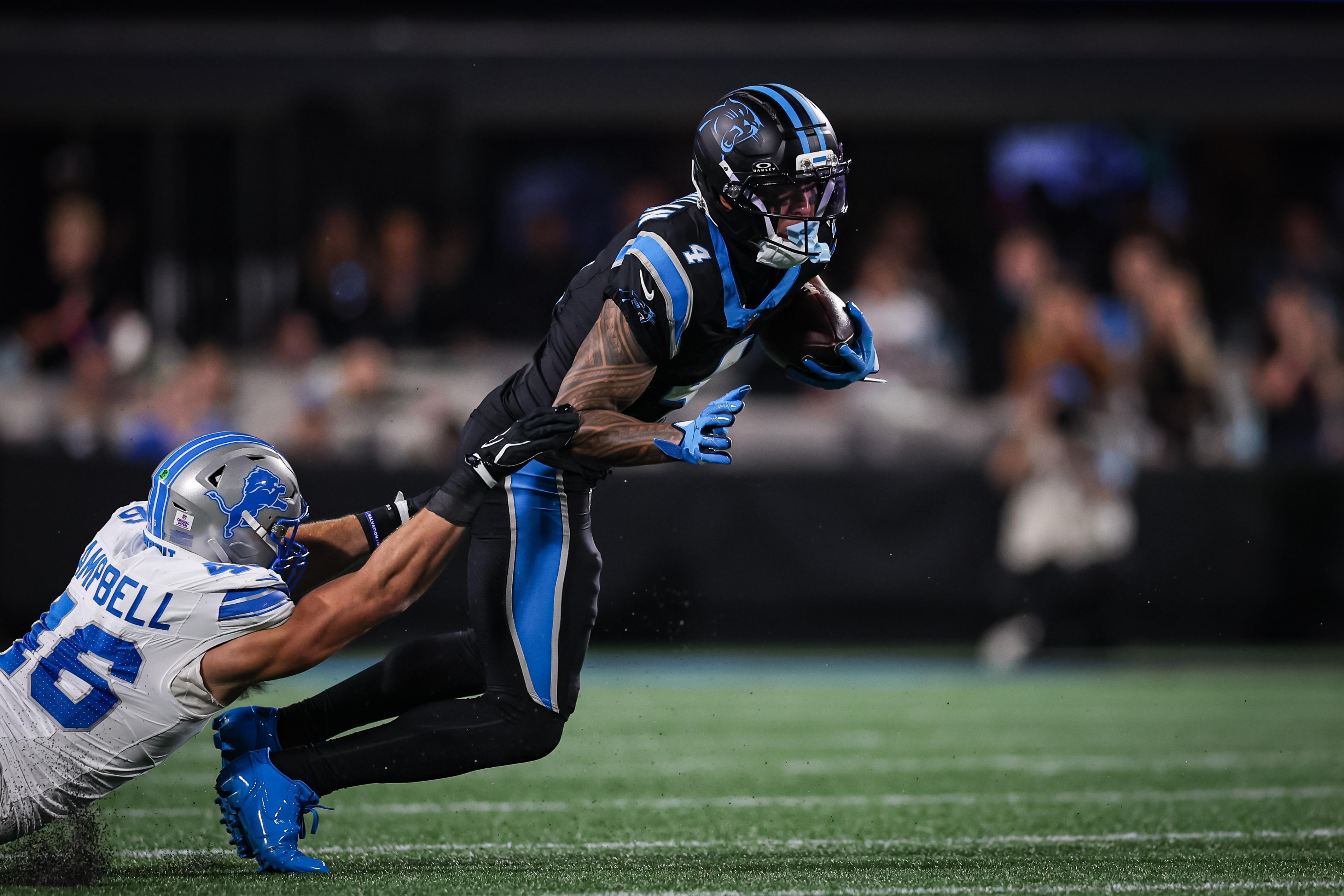 Jack Campbell, dos Lions, tenta derrubar Tetairoa McMillan, dos Panthers, em 4 de outubro de 2026.