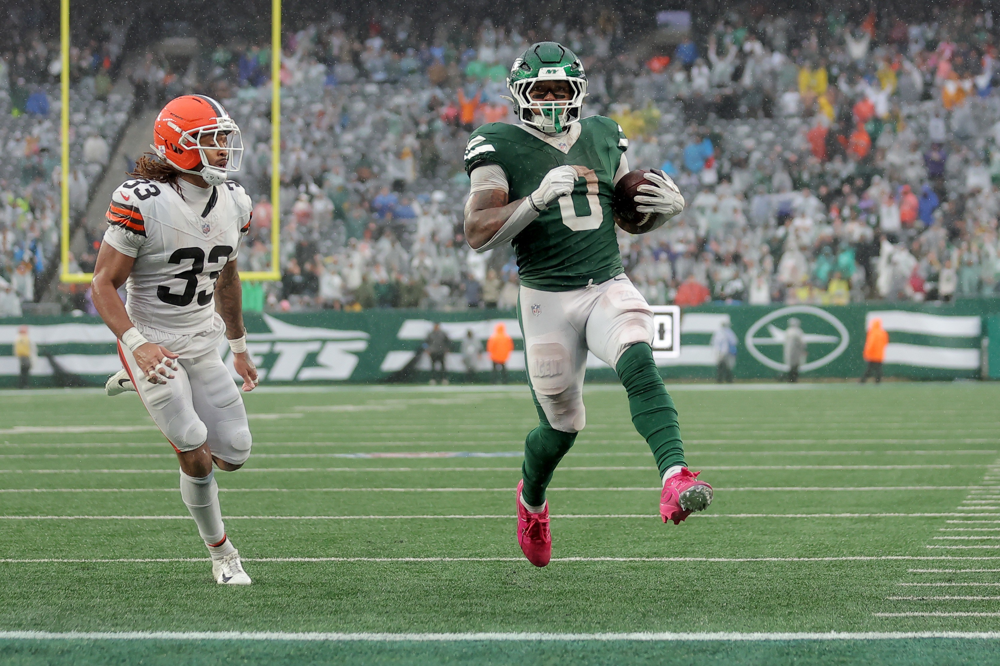 Braelon Allen corre para touchdown dos Jets diante de Ronnie Hickman, dos Browns.